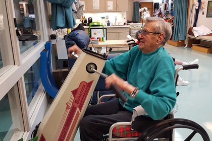 Man using rehabilitation equipment at Brevillier Village.