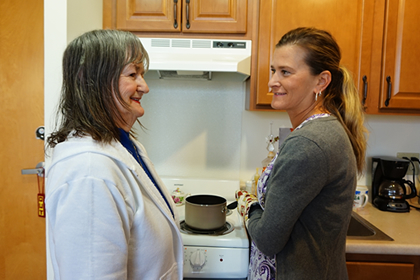 Brevillier village volunteer spending time with resident.