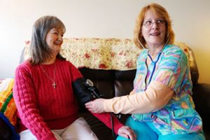 Brevillier Village nurse taking residents blood pressure.